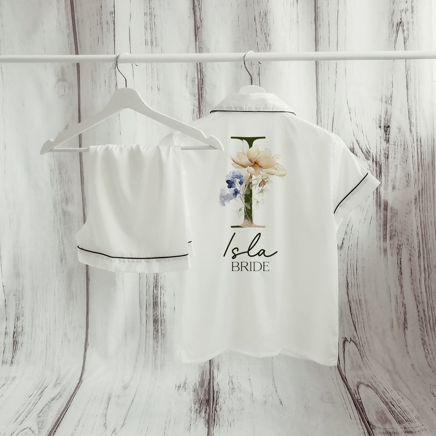 A beautifully designed personalised wedding robe and pyjama set featuring a delicate floral initial design. Perfect for brides, bridesmaids, and the bridal party, available in various sizes for a timeless and sophisticated look.

